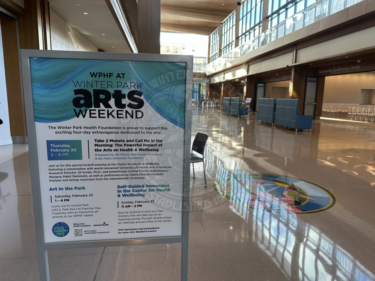 A sign that says Winter Park Arts weekend with details about the event