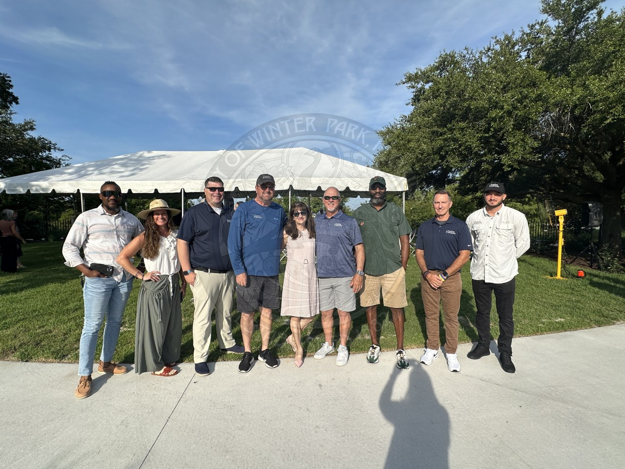 A group of people smiling and standing next to each other. 