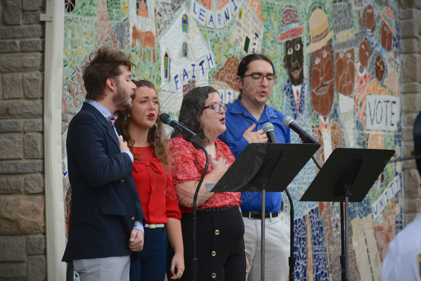 four singers on stage at the veterans day event