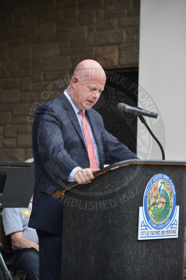 man standing behind podium giving a speech