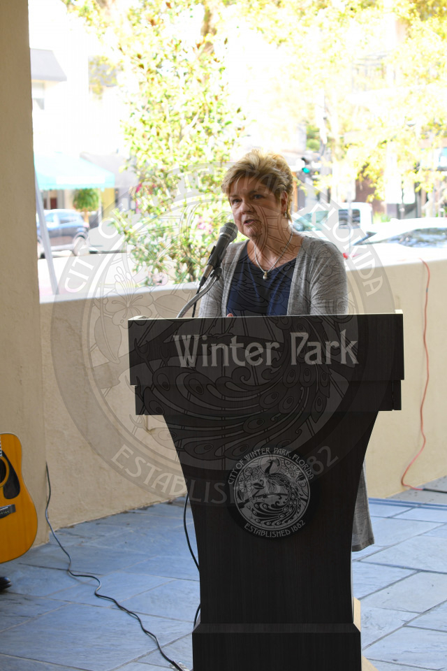 Commisioner Carolyn Cooper standing behind podium and speaking into microphone