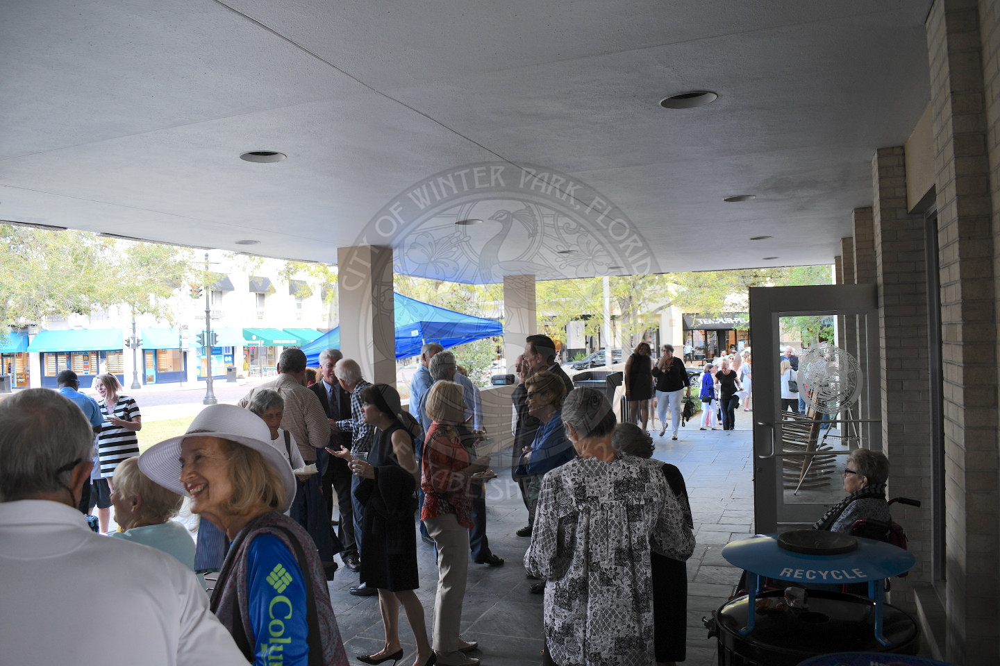 group of people mingling outside of city hall