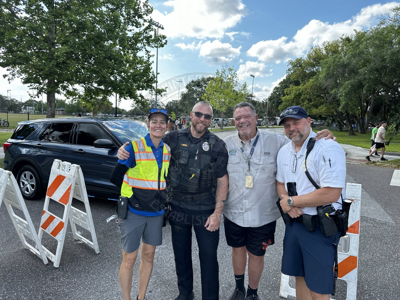 group of people standing next to each other smiling.