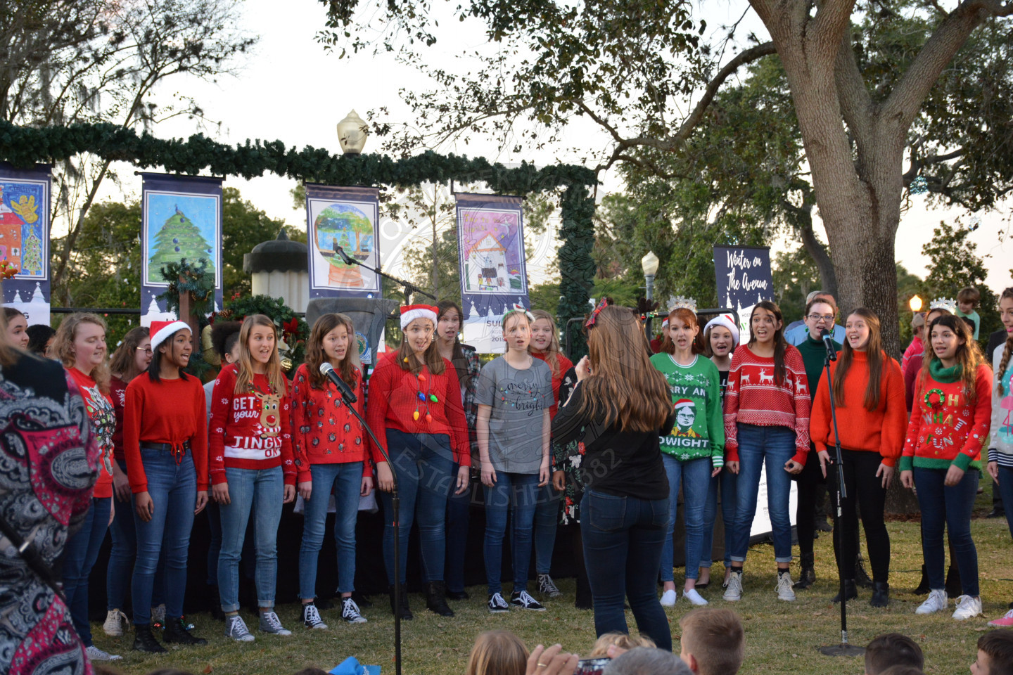 group of teens singing in front of the stage at Winter on the Avenue
