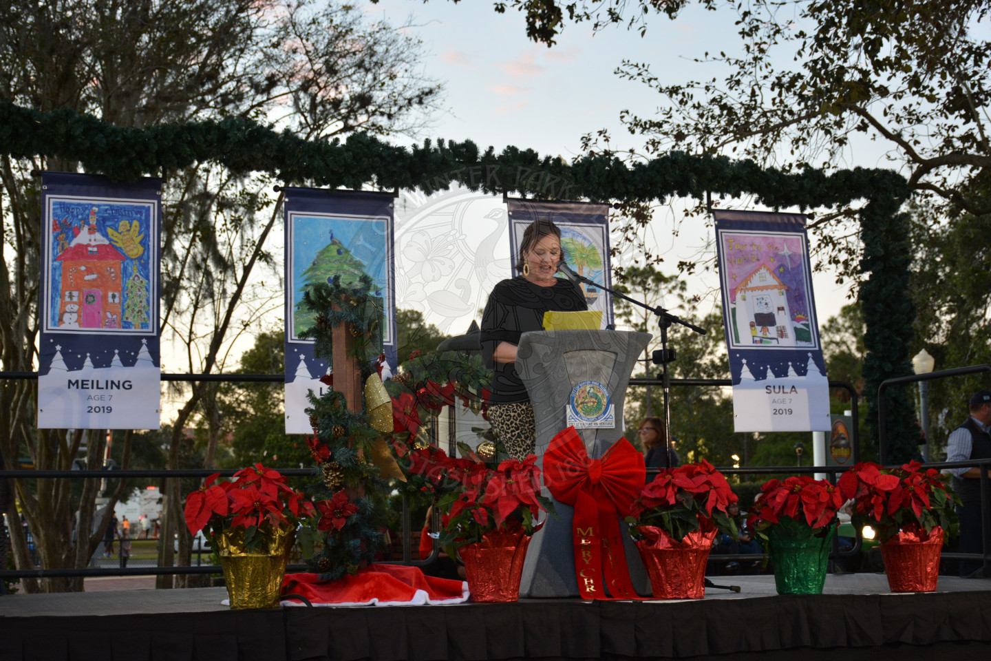 Chamber President Betsy speaking on stage behind a podium