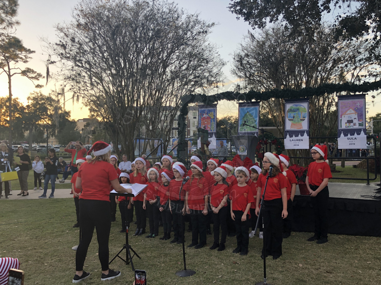 elementary kids singing in front of the stage at Winter on the Avenue