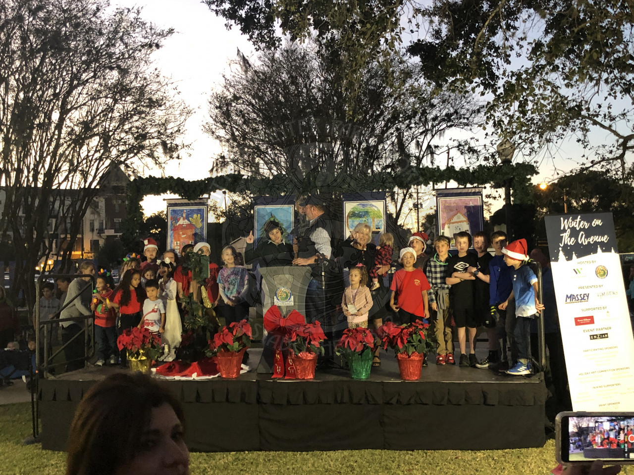 Group of kids on stage with Mayor Steve Leary counting down the lighting of the holiday tree