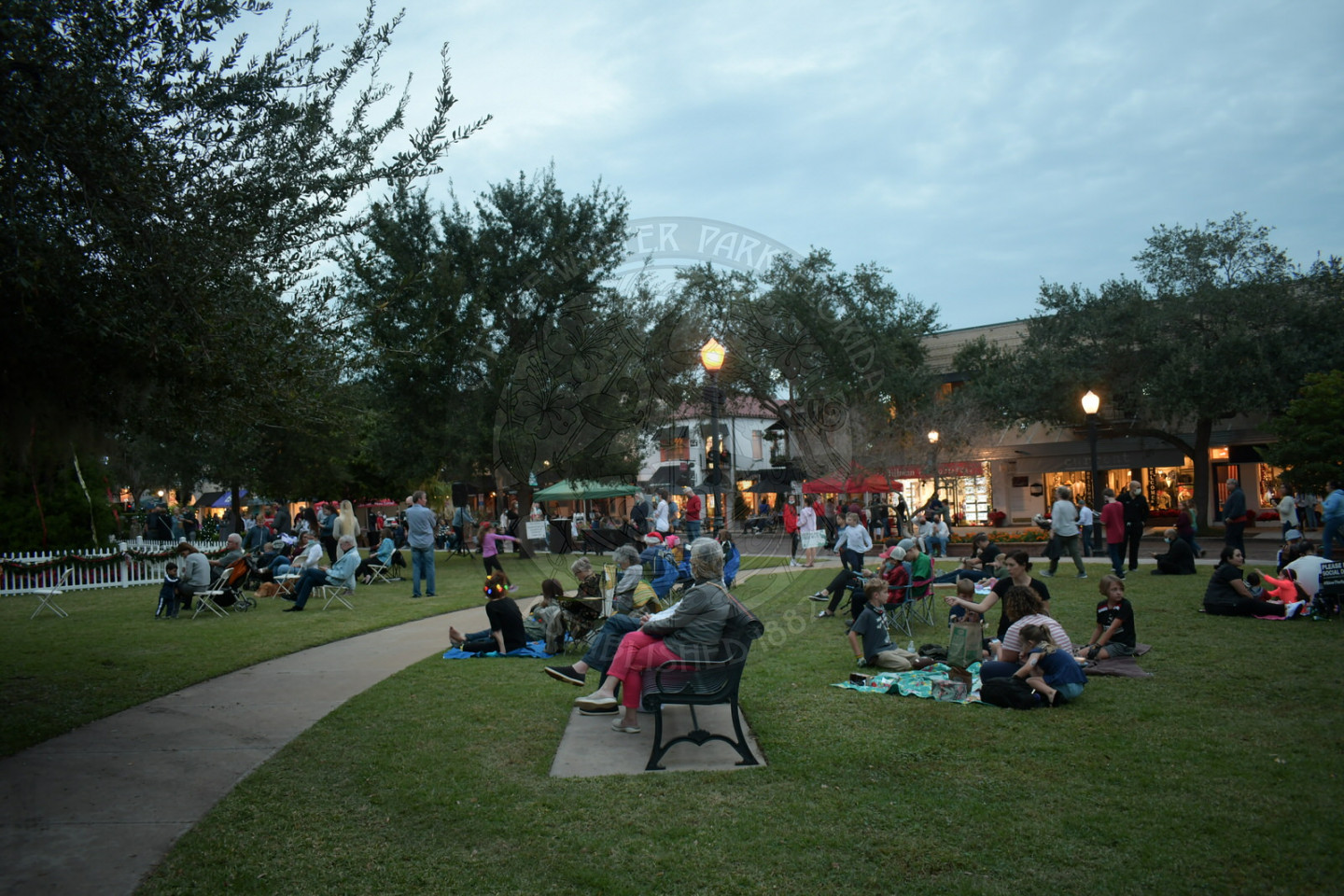 people sitting outside in groups