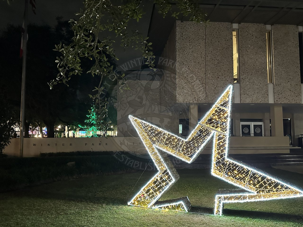 a very lighted star that is on the ground in front of city hall