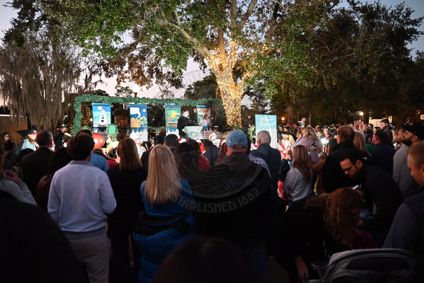 a woman on a stage standing behind a podium speaking to the audience.