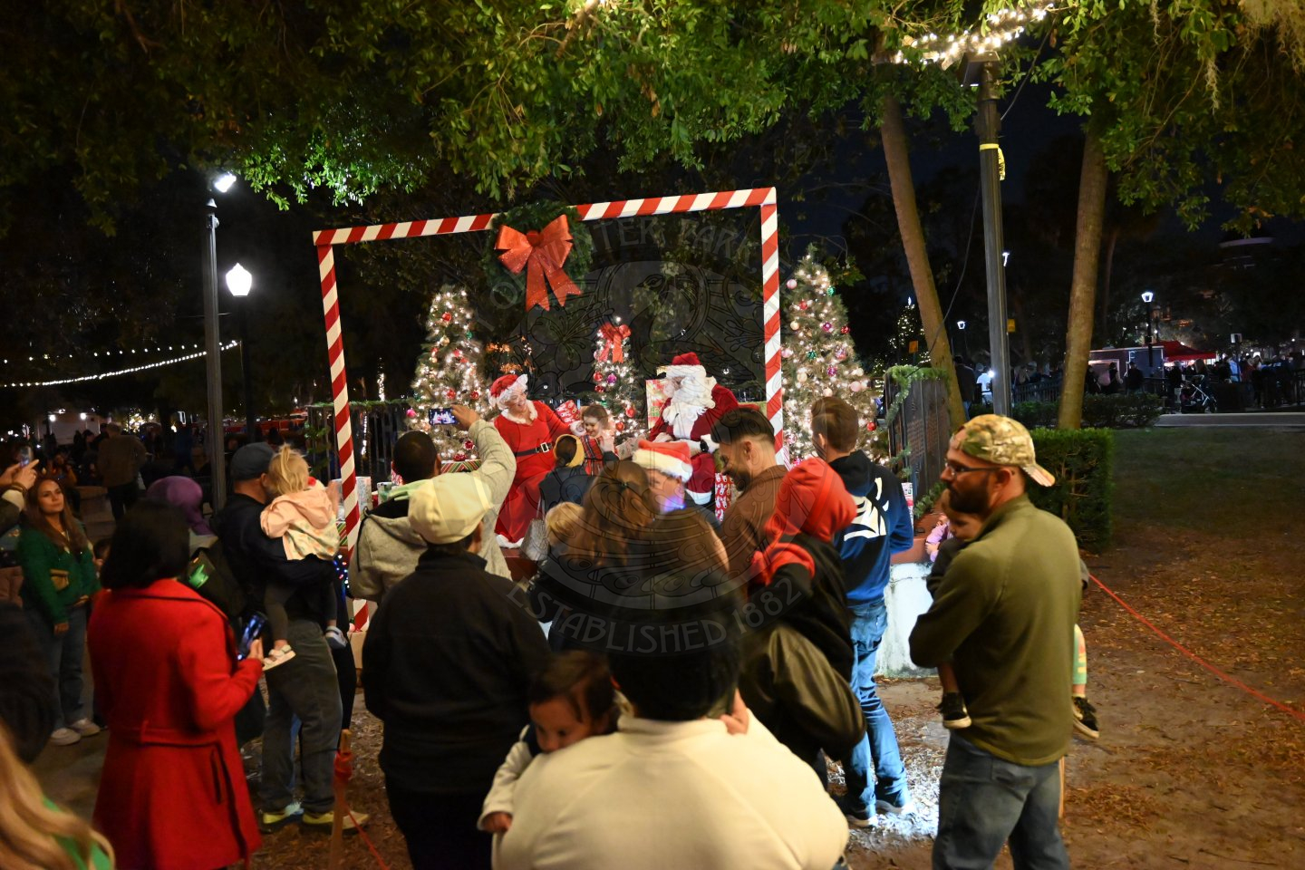 Parents and kids waiting in line to visit santa and Mrs. Claus.