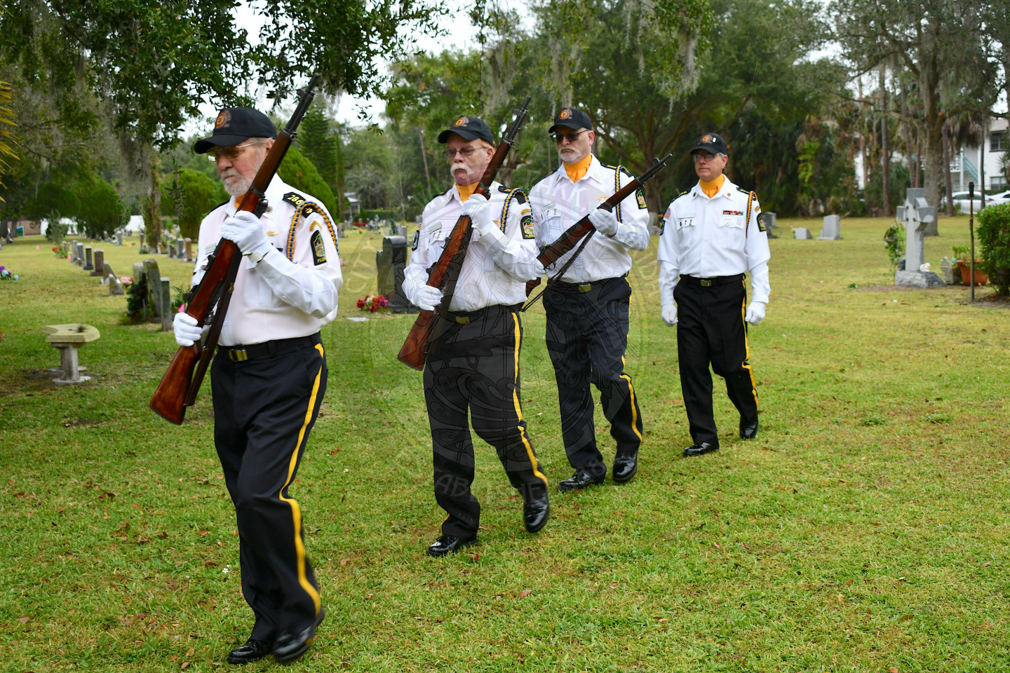 the honor guard walking away while holding their guns.