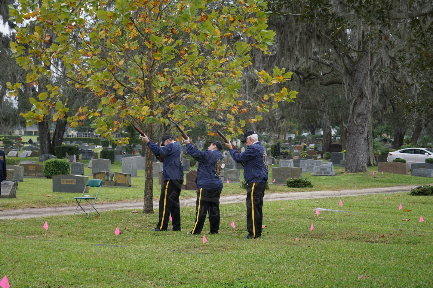 3 people from honor guard shooting off their guns into the air
