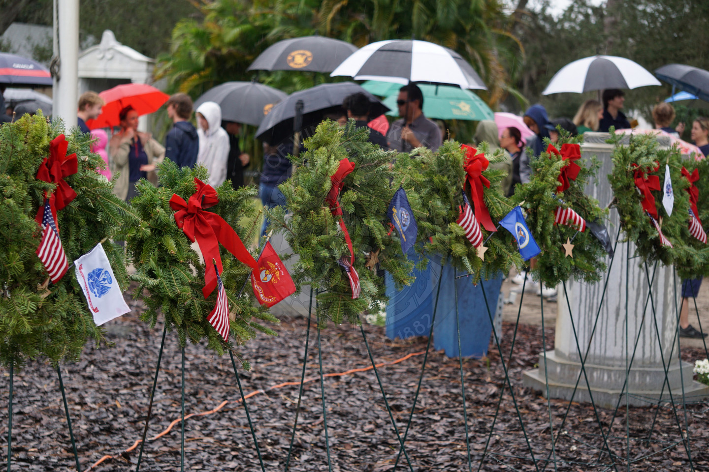 six wreaths with different military branches lying on easles