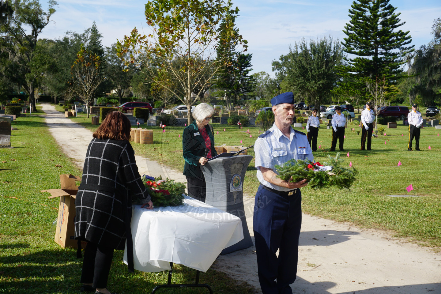 Veteran walking to place wreath on pedestal