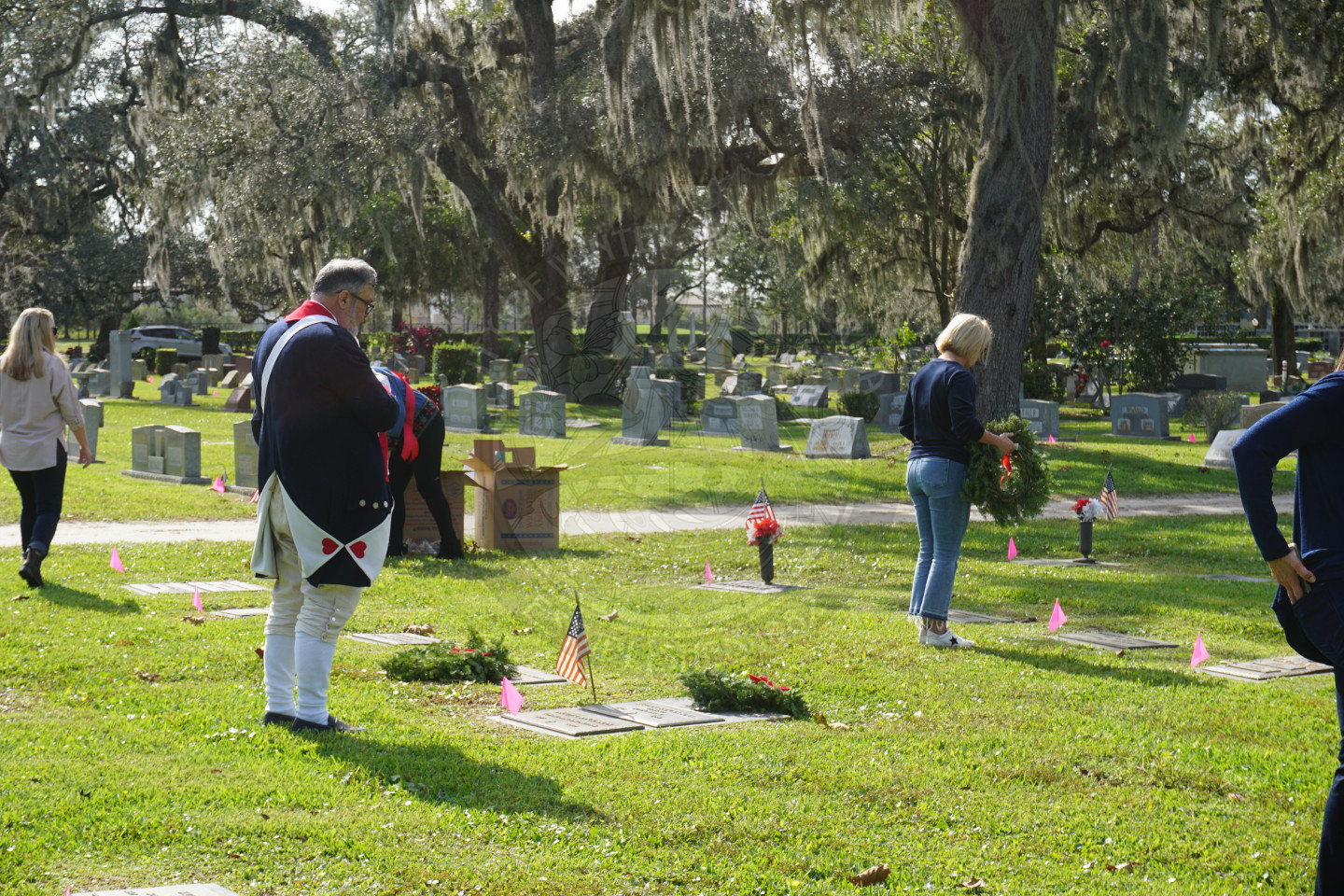 Man laying down wreath on Veterans grave