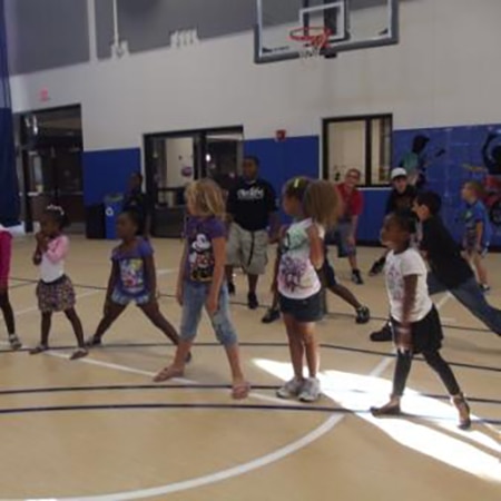 Kids excercising in the Community Center basketball court