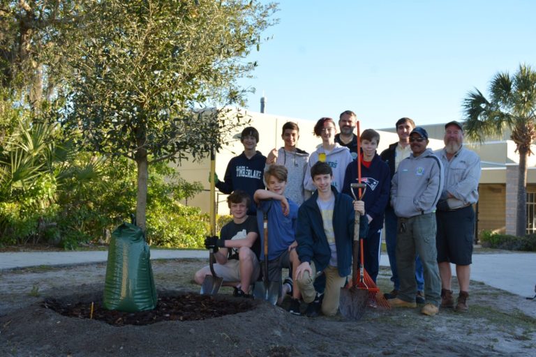 Glenridge Middle School kids posing beside a newly planted tree
