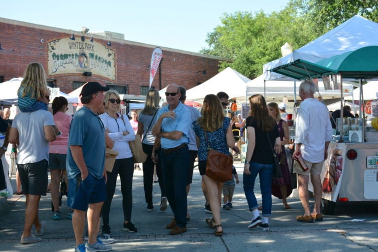 People gathered in the parking lot of the Winter Park Farmers’ Market during its 40th Anniversary event
