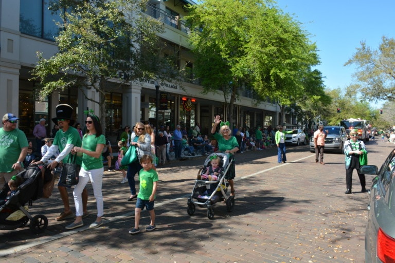 People walking down Park Avenue during St. Patrick's Day parade in Winter Park, Florida