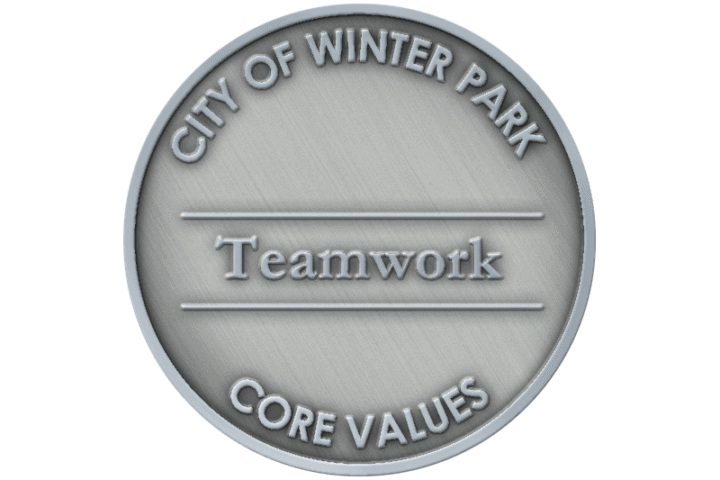 A coin representing the core value of Teamwork