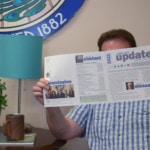 Person sitting and reading a newsletter