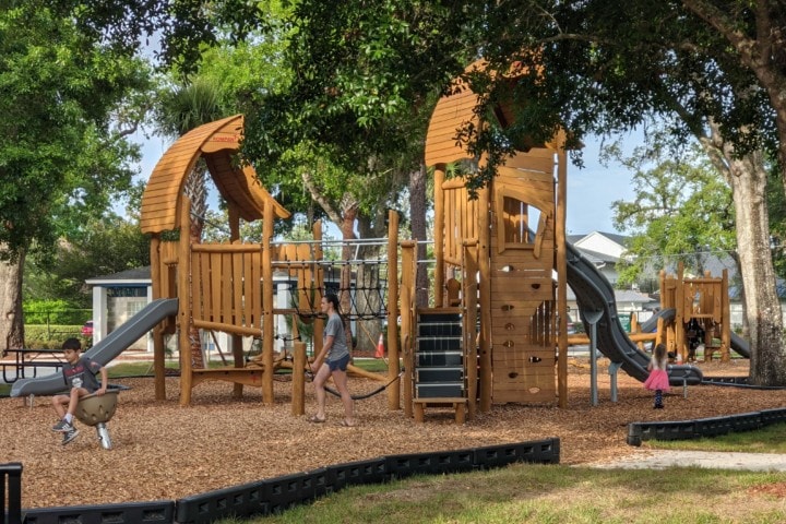 large wooden structures with slides, walking & climbing nets, meant for older children