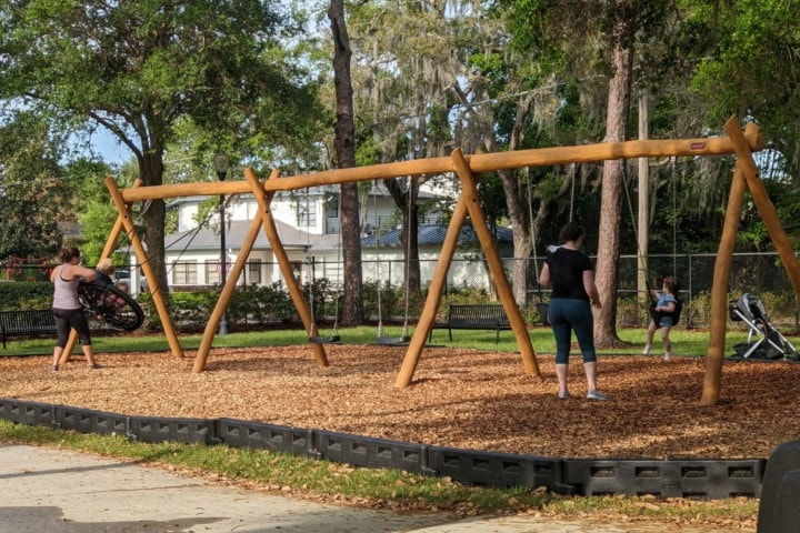 wooden structure holding several swings