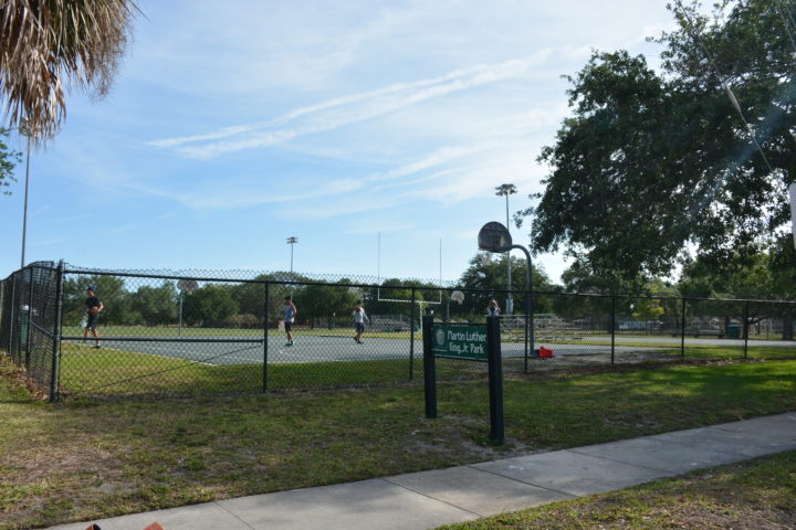 Basketball court with a metal gate around it