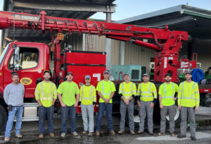 nine electric linemen with bucket truck