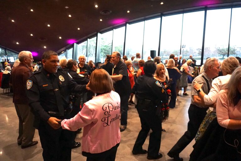 ballroom full of winter park police department officers and seniors dancing the night away.