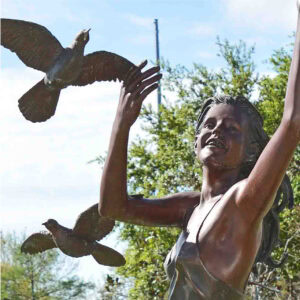 a girls face smiling while dancing with doves.