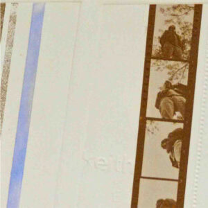 a roll of printed film on white paper with stripes on the left side of the film.