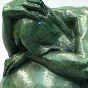 a zoomed in view of sculpture of a mom crying.