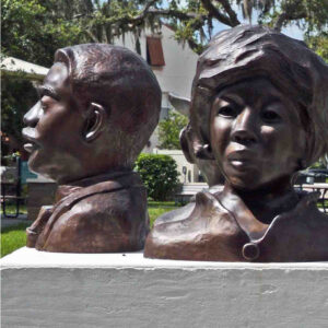 two bronze busts, one male and one female