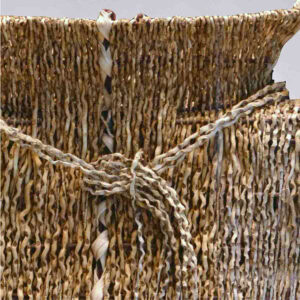 a zoomed in image of a woven basket with dark and light fibers.