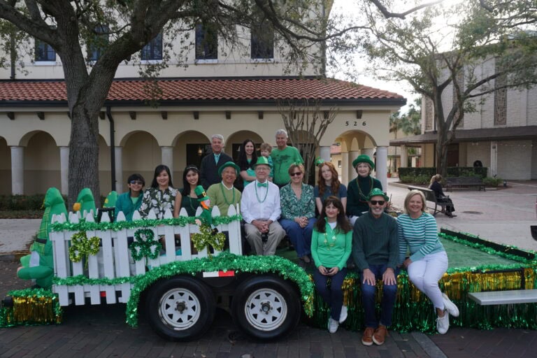 Elected officials and their families sitting on a trailer smiling.