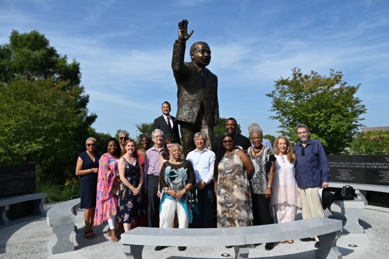 a group of people standing in front of the Martin Luther King Statue