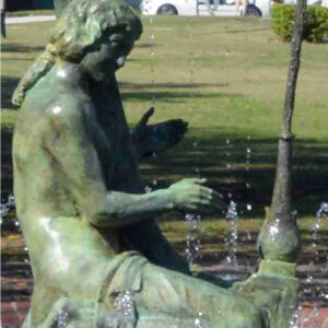 sculpture of a woman playing a harp in a fountain