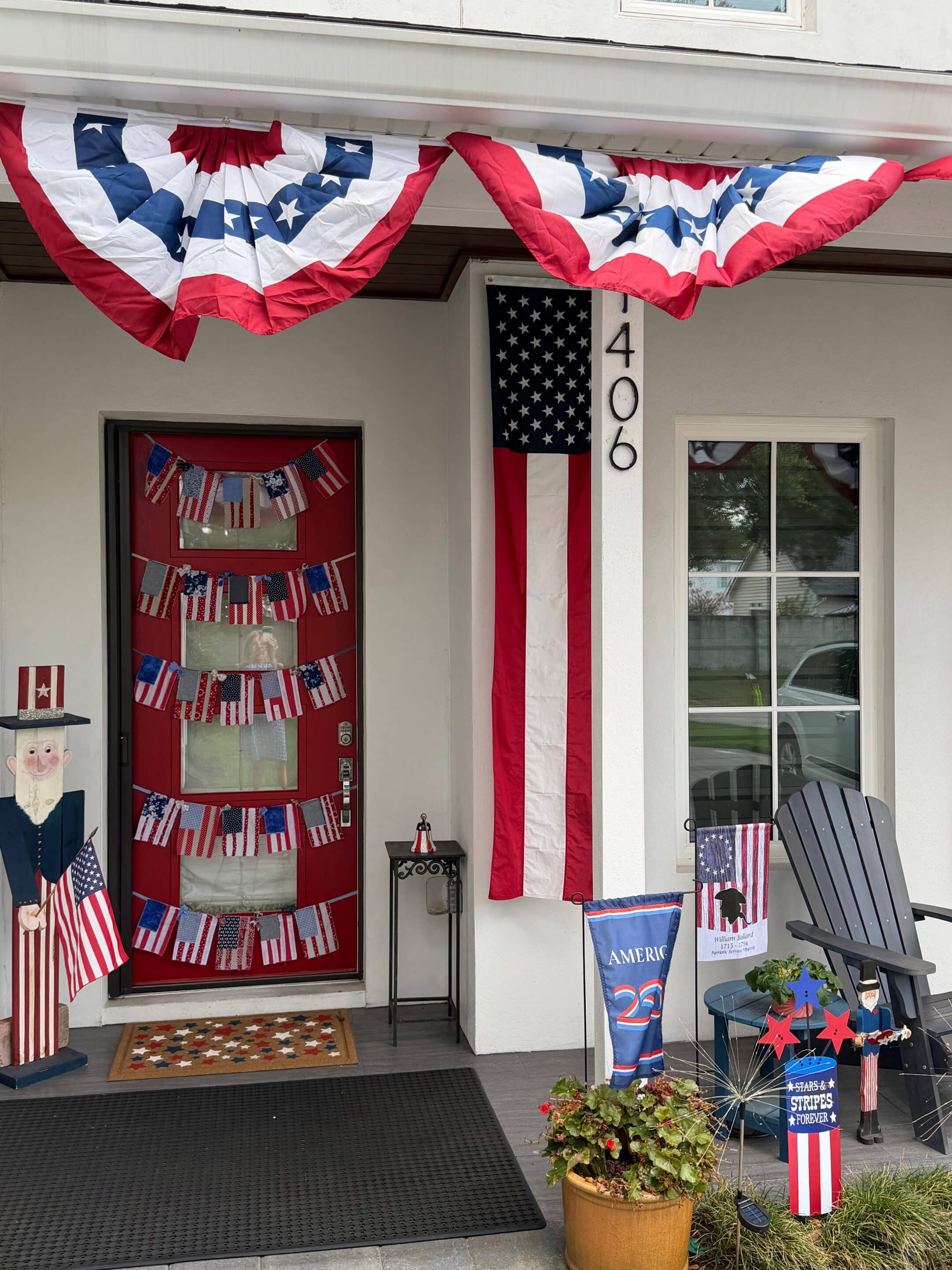 Front porch decorated with American flags and patriotic items for Independence Day.