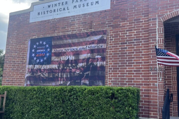 Winter Park Historical Museum with a Stars, Stripes, and Stories USA 250th anniversary banner and an American flag outside.