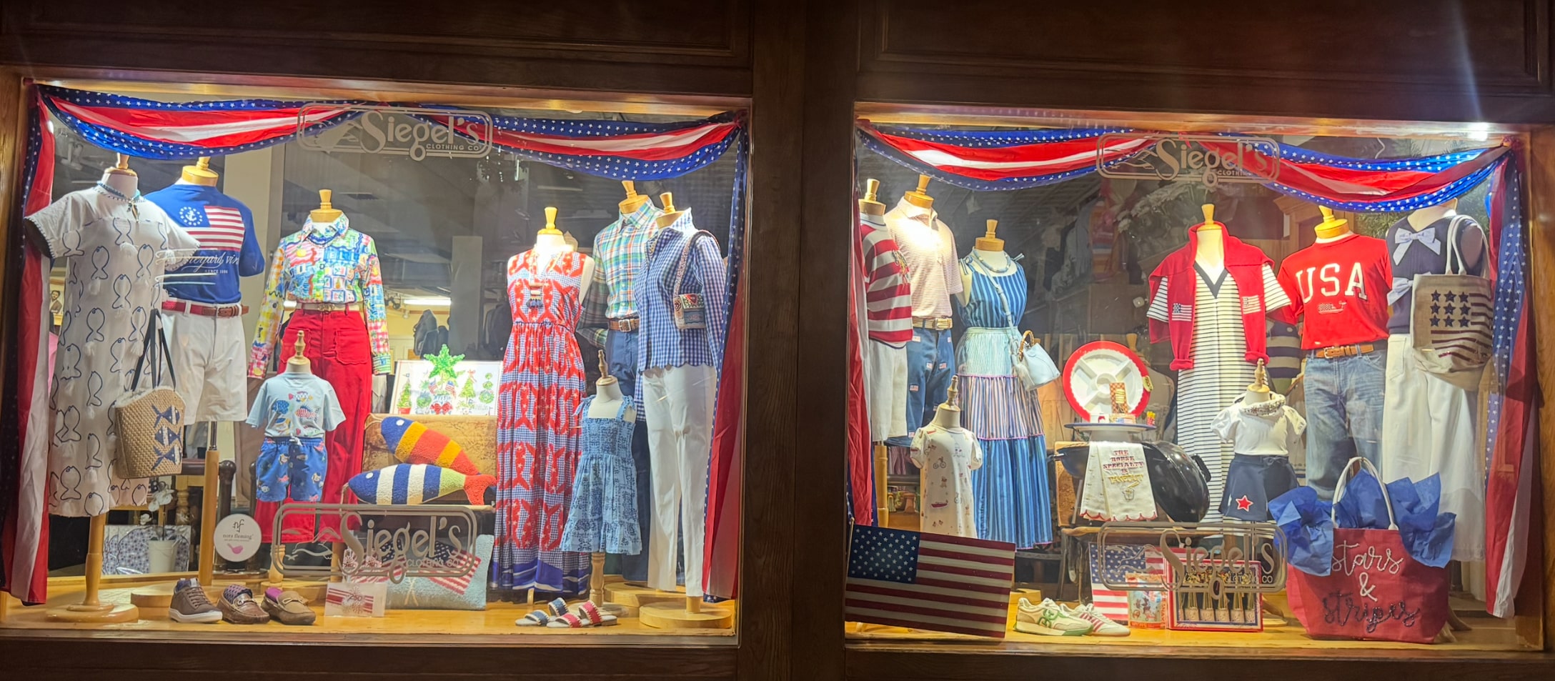 Storefront window displays mannequins in patriotic red, white, and blue clothing with American flag decorations.